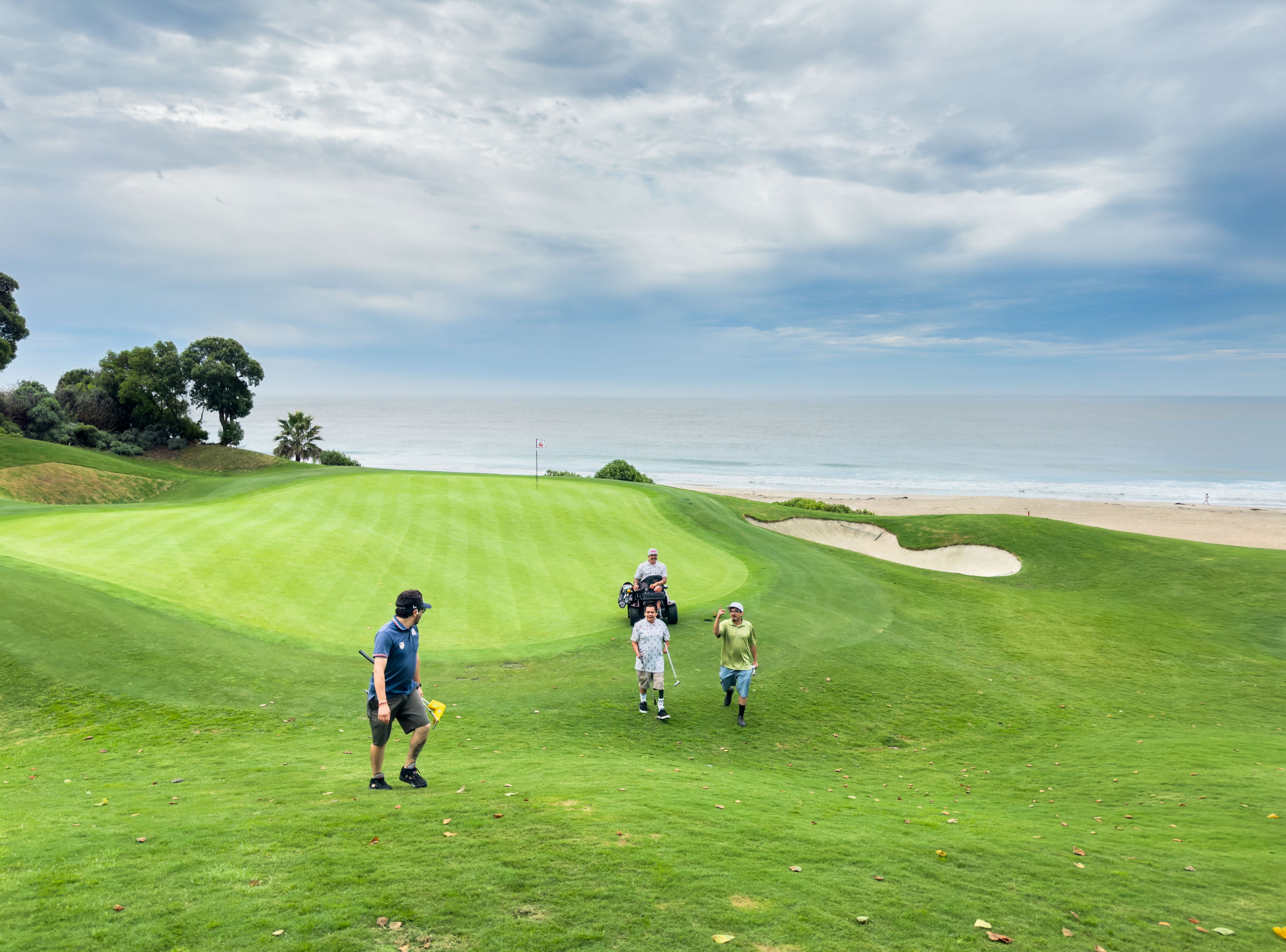 Amplife® Foundation & Amplife® Founder Abdul Nevarez with Team Amplife® Ambassador Oscar Loreto, Jr. and two other Amplife® Supporters exiting a golf course green on the coast