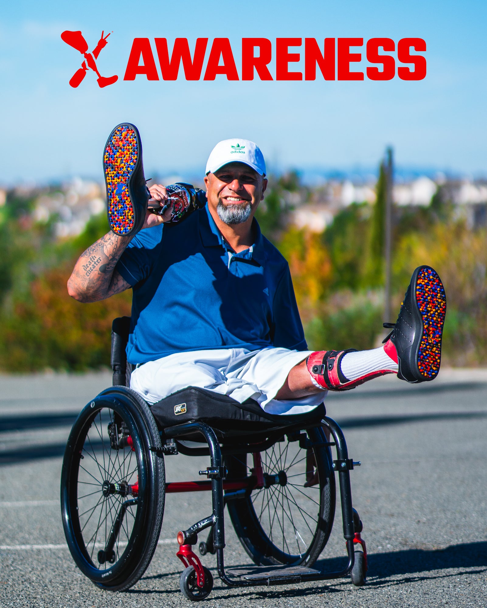 Amplife® Foundation & Amplife® Founder Abdul Nevarez holding his prosthetic leg while in his wheelchair