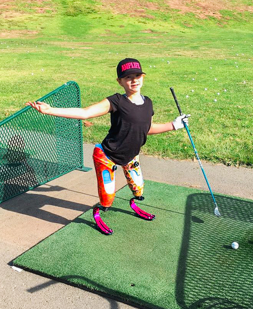 Portrait of a  kid Amplife® Supporter on the driving range