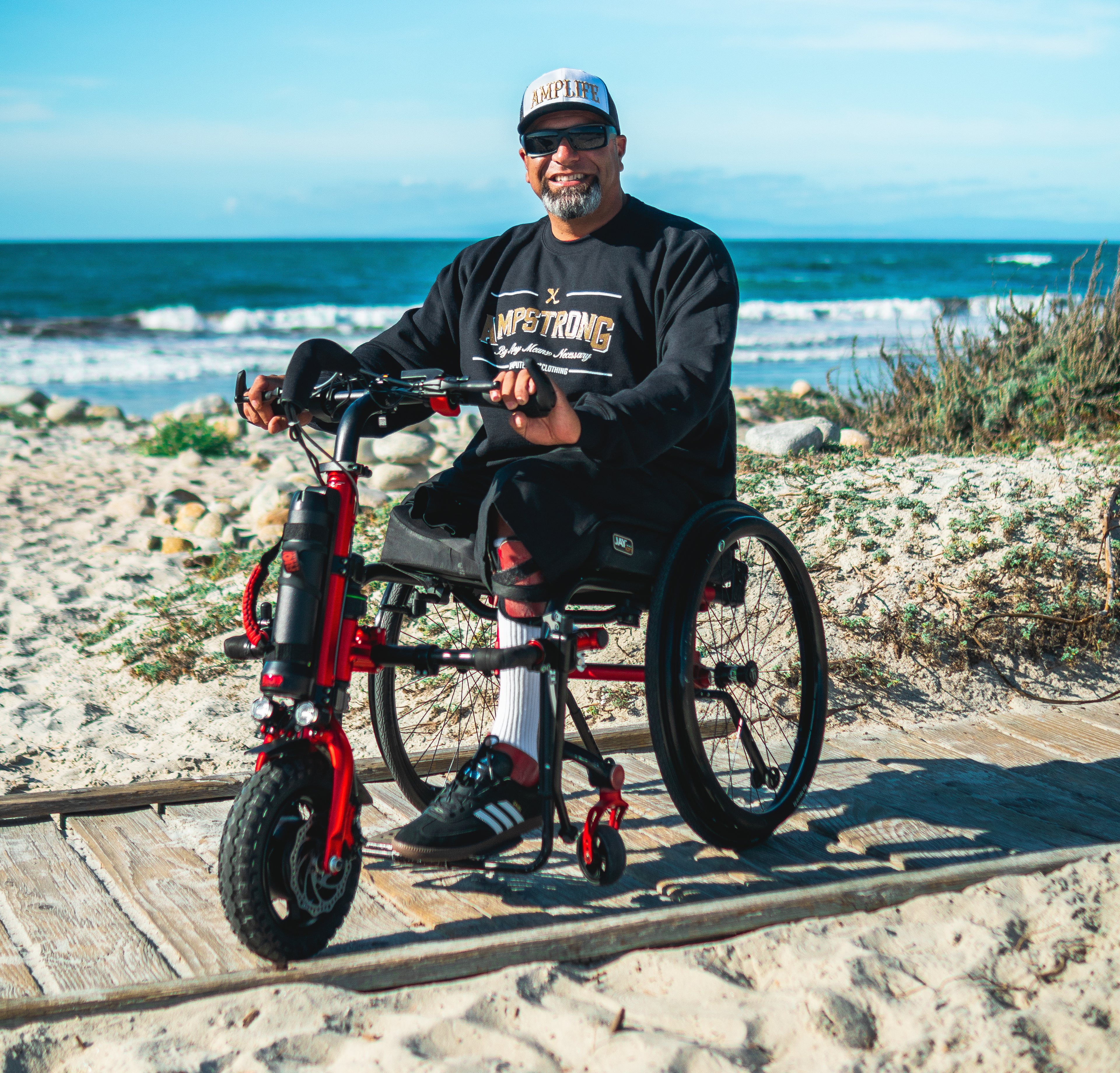 Portrait of Amplife® Foundation & Amplife® Founder Abdul Nevarez on his Rio Mobility Firefly 2.5 Electric Scooter Wheelchair Attachment at Pebble Beach