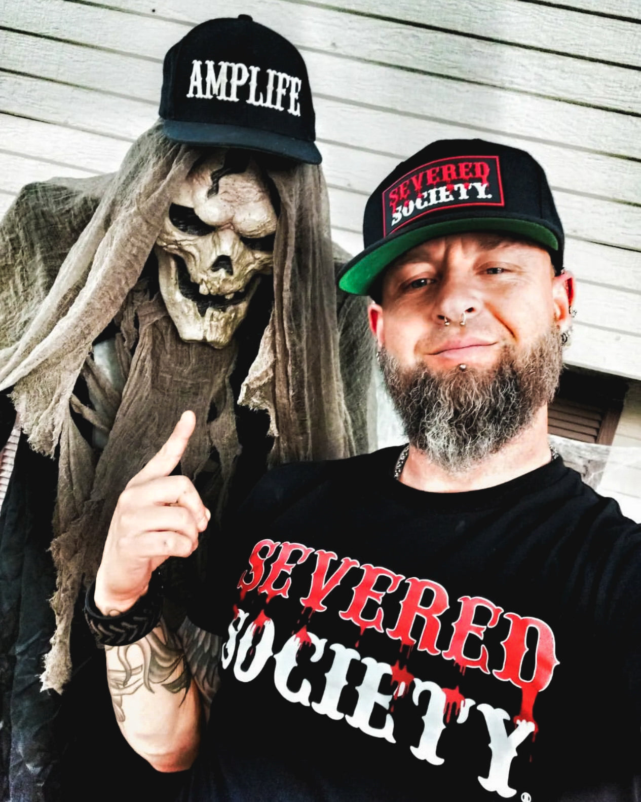 Portrait of Team Amplife® Ambassador Jason Loftiss next to a skeleton wearing an Amplife® Hat 