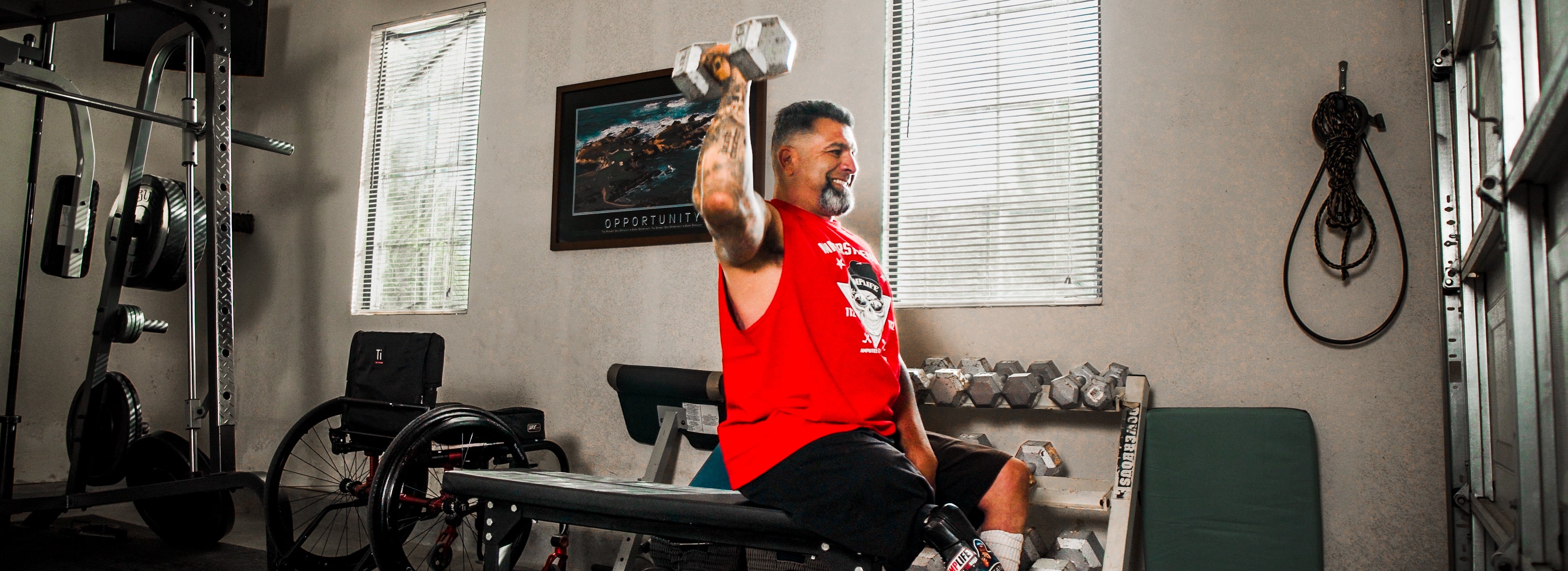 Amplife® Foundation & Amplife® Founder Abdul Nevarez shoulder pressing in his home gym