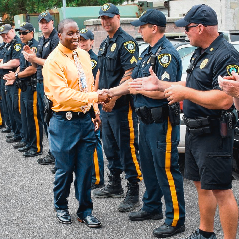Team Amplife® Ambassador Michael Braxton Jr. shaking hands of the police force where he became New Jersey's 1st New Jersey's 1st Amputee K9 Officer