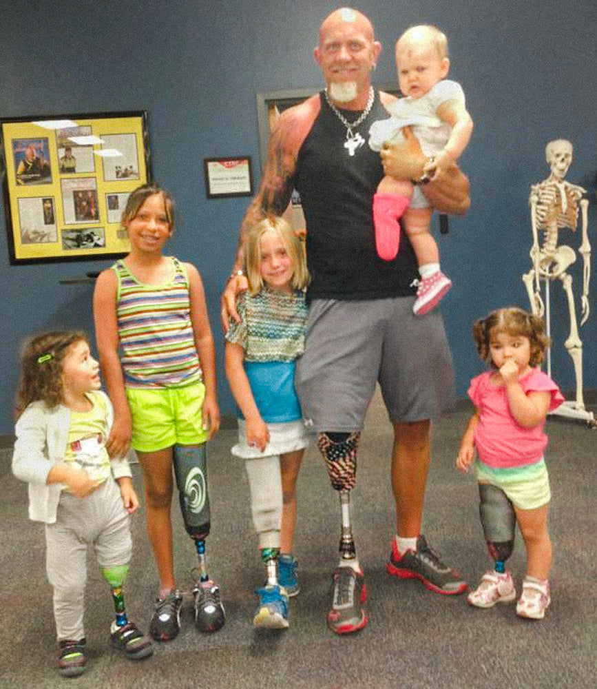 Amplife® Love Cause 50 Legs group photo of multiple kid amputees with 50 Legs Founder Steve Chamberland