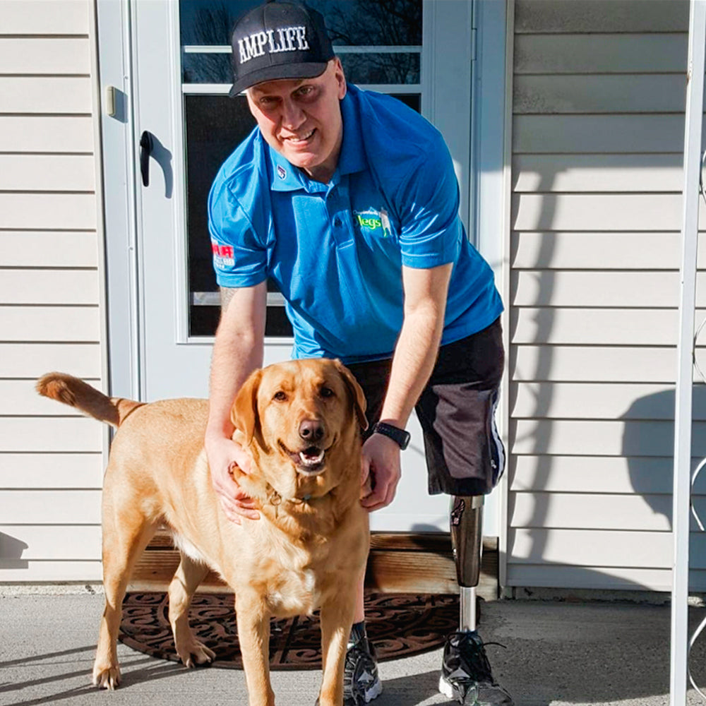 Portrait of Amplife® Supporter wearing the Amplife® x 50 Legs Polo with his dog