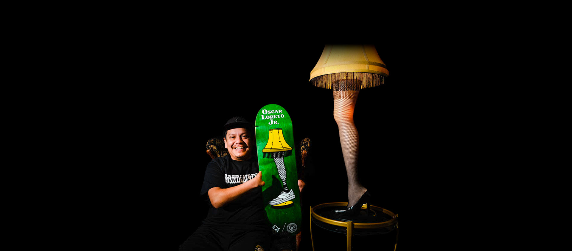 Portrait of Team Amplife® Ambassador Oscar Loreto, Jr. with his signature skateboard, "An Oscar Story", next to the Christmas Story Leg Lamp